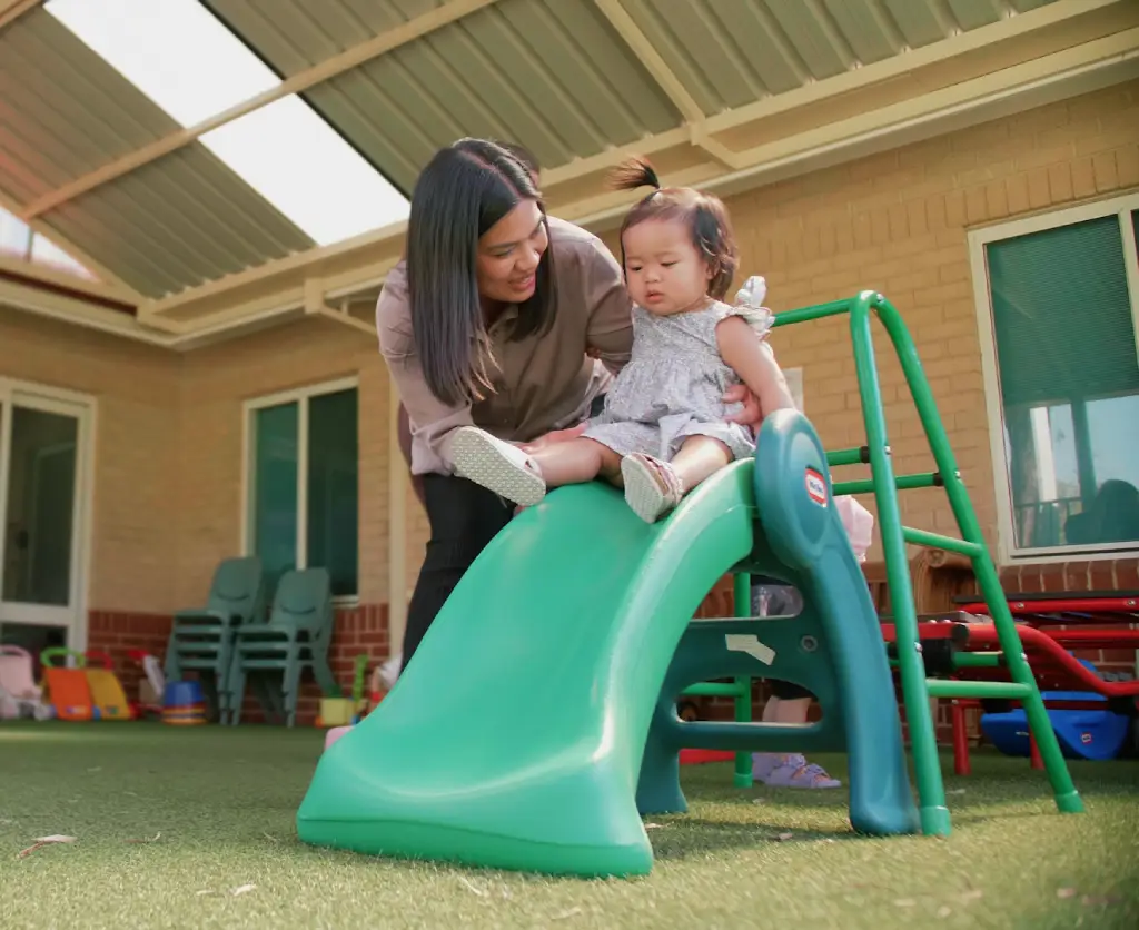 girl assisted down slide