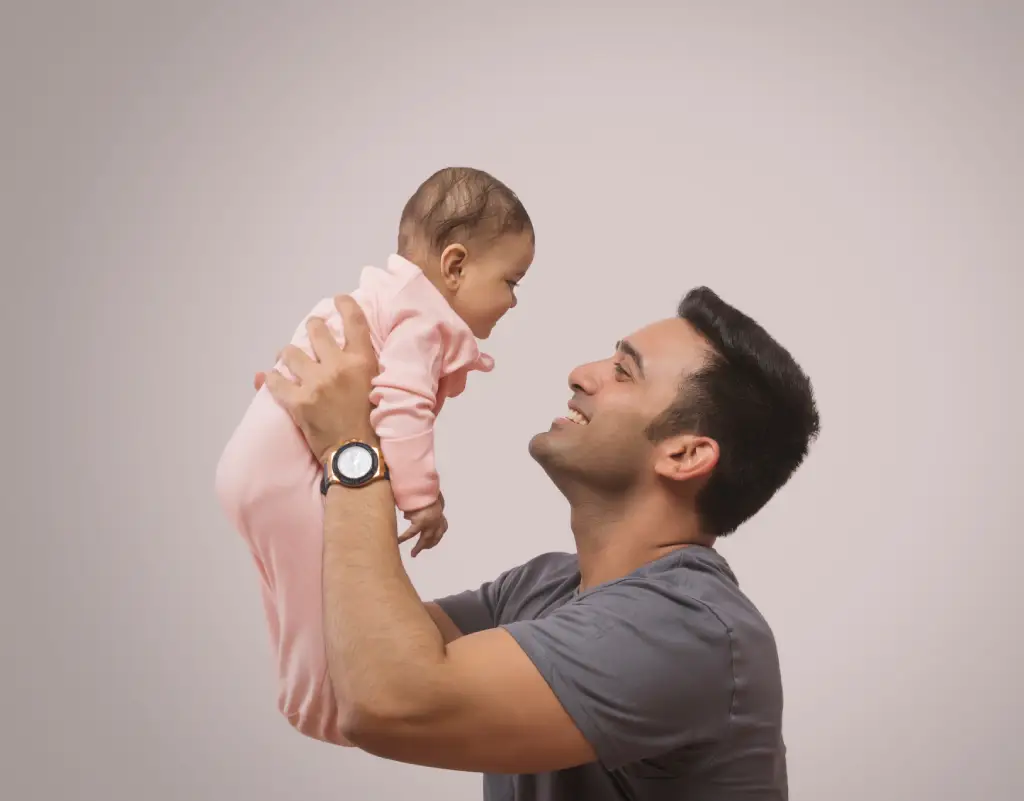 man playing with baby